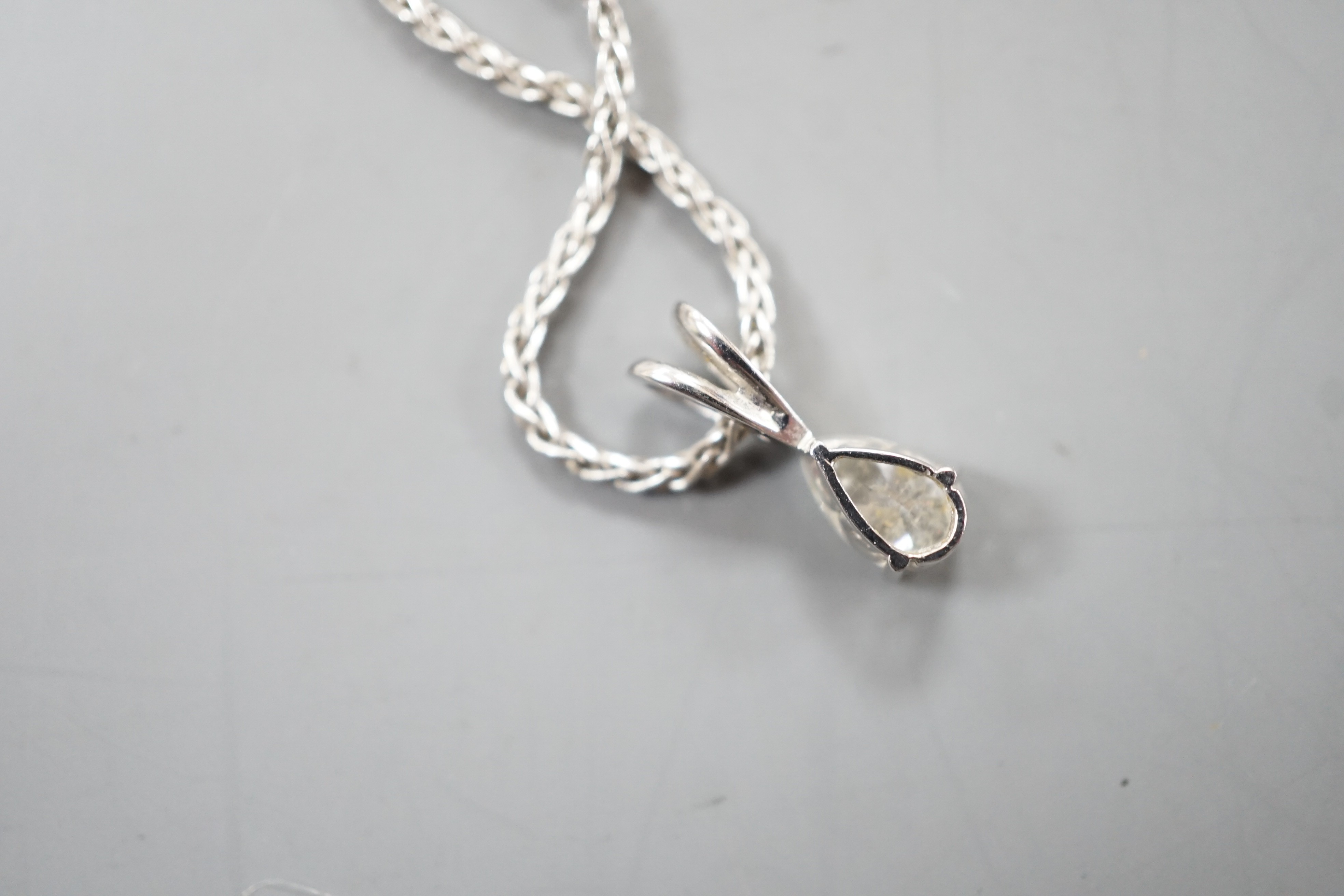 A modern white metal and pear cut diamond set pendant, 13mm, on an 18ct white gold chain, 39cm, gross weight 4.5 grams.
